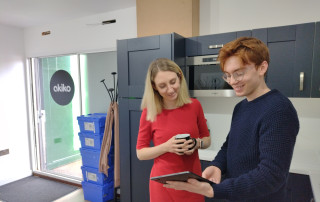 Deputy Police and Crime Commissioner for Surrey Ellie Vesey-Thompson with graphic design student Jack Dunlop inside the Akiko Design studios in Bramley