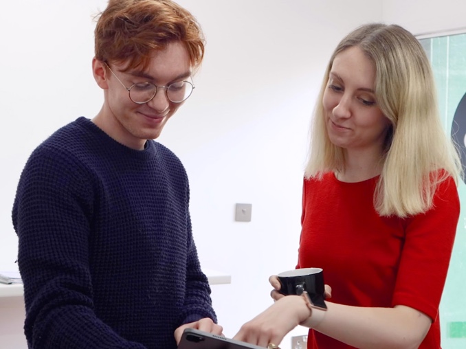 Deputy Police and Crime Commissioner Ellie Vesey-Thompson looking at an ipad with a student from Surrey