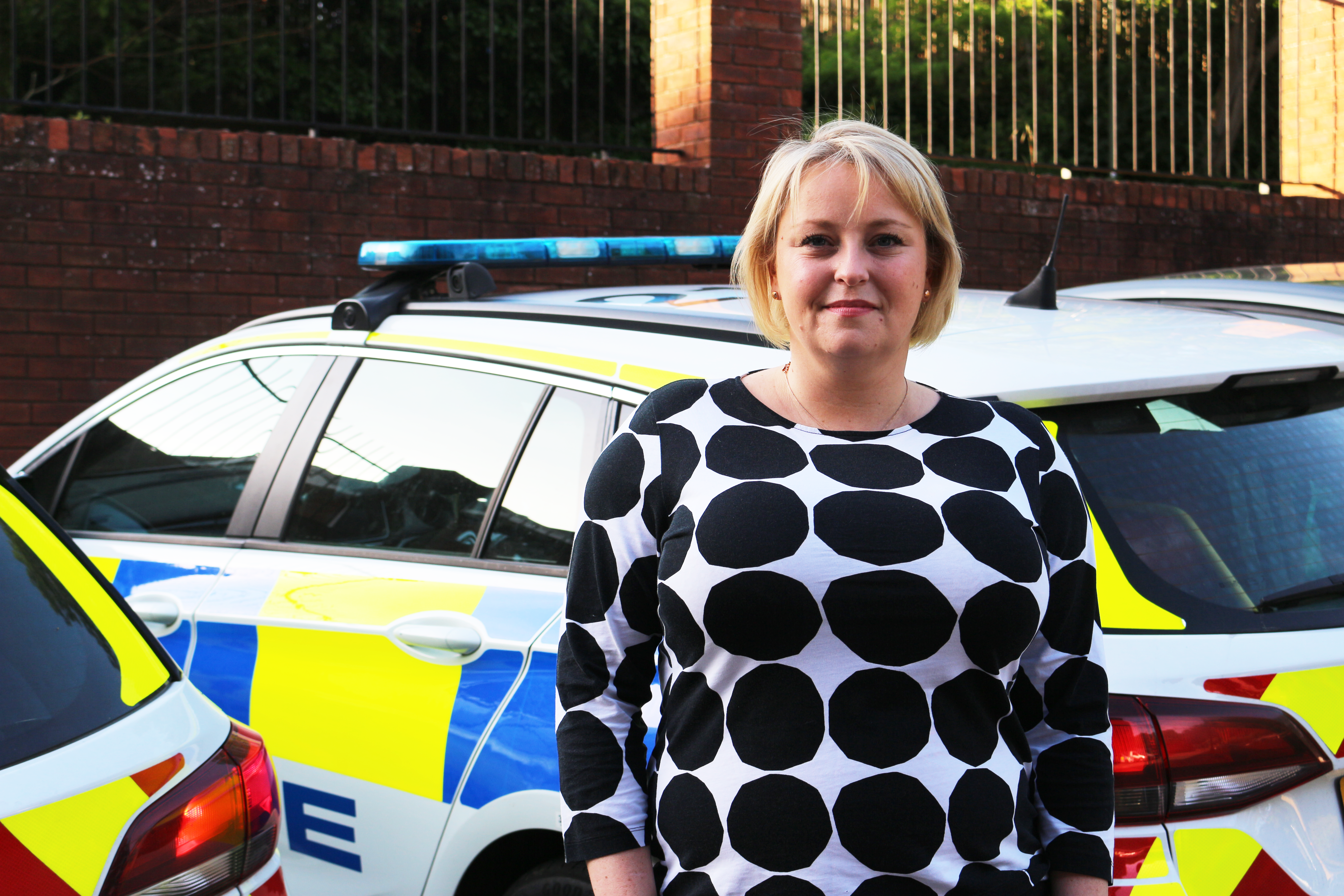 Police and Crime Commissioner Lisa Townsend standing next to a police car