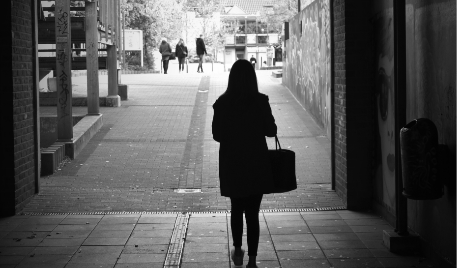 woman walking in a dark underpass