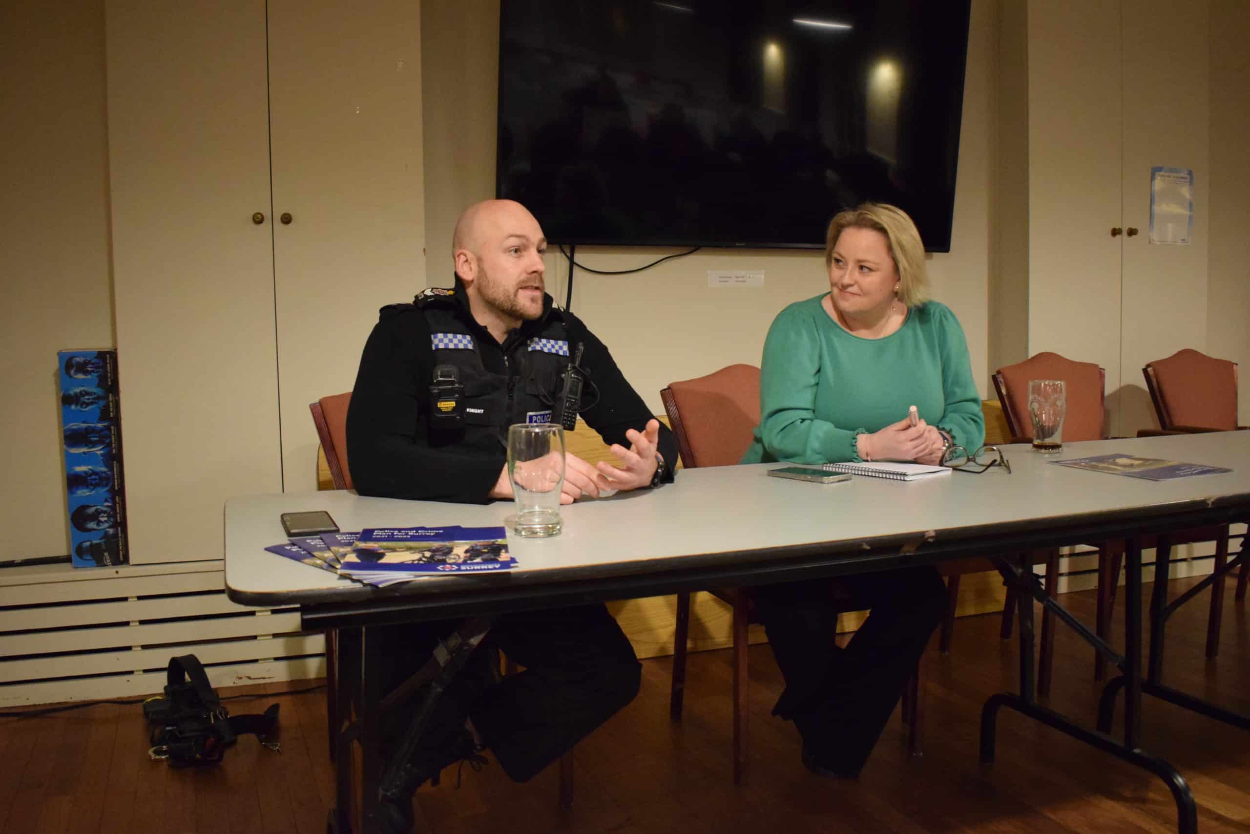 Police and Crime Commissioner Lisa Townsend sat at a desk with local police officer in a town hall
