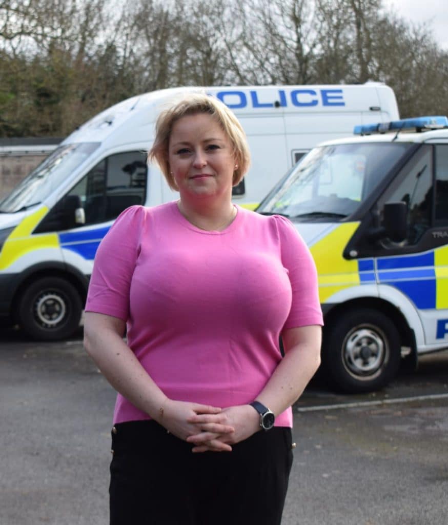 Police and Crime Commissioner Lisa Townsend standing in front of Surrey Police vans