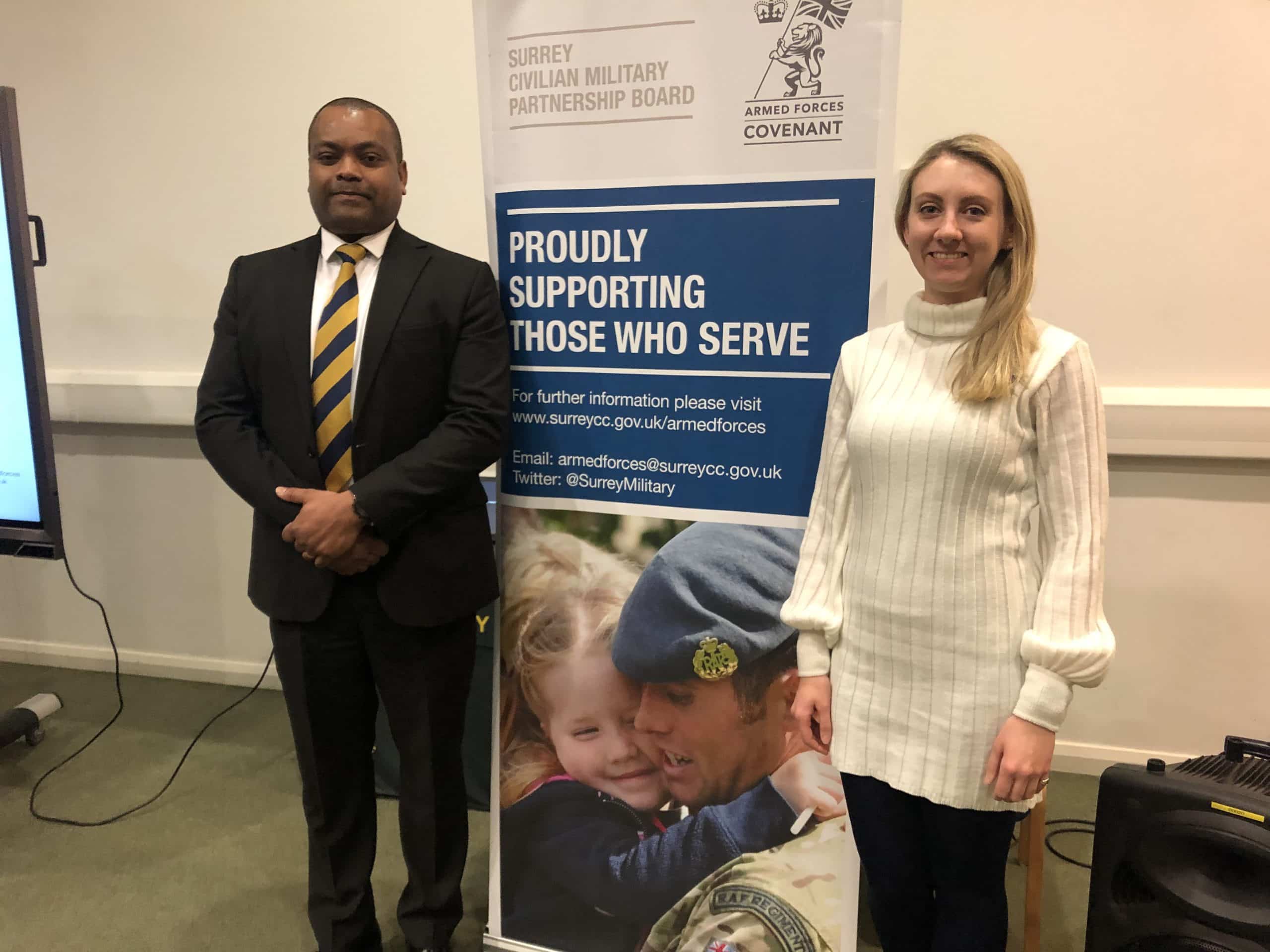 Deputy Police and Crime Commissioner Ellie Vesey-Thompson and representative of Surrey Civilian Military Partnership Board in front of their banner