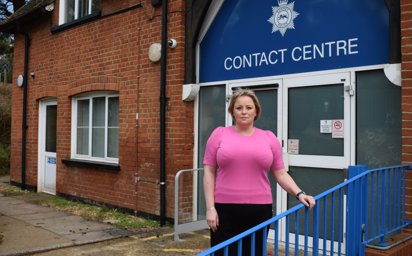 Police and Crime Commisisoner for Surrey Lisa Townsend standing outside the Surrey Police Contact Centre with 'Contact Centre' visible on building sign behind her.