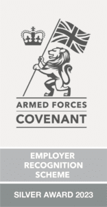 Logo for Silver level of Armed Forces Covenant Employer Recognition Scheme. Grey image on white background of the English royal lion holding a Union Jack flag with a crown above it. Text says Silver Award 2023