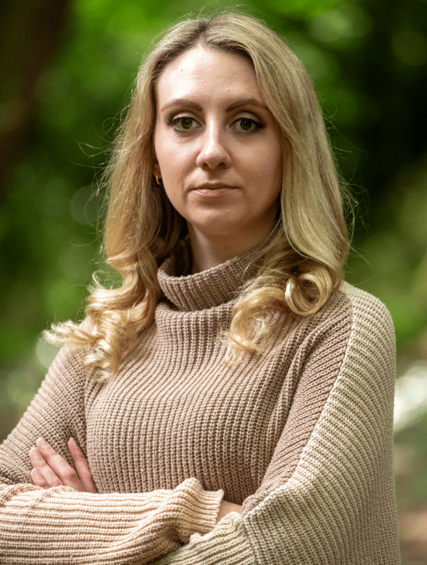 Deputy Police and Crime Commissioner Ellie Vesey-Thompson, a blonde woman who wears a beige roll-neck jumper, looks directly into the camera. Her expression is stern and her arms are folded.