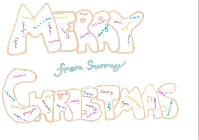The image shows the word 'Merry Christmas' in gold bubble letters, and 'from Surrey' in green. Inside the bubble letters are the names of some Surrey towns and villages.