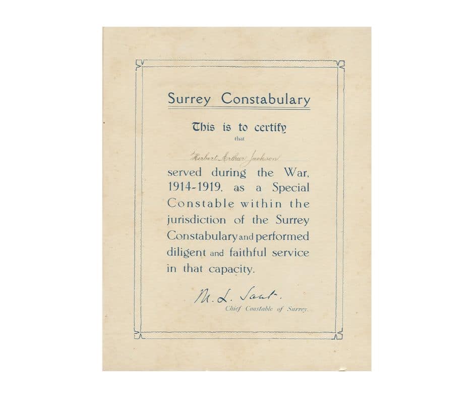 The image shows a certificate printed on yellow paper with blue text. The text has a border around it. It reads: " Surrey Constabulary. This is to certify that Herbert Arthur Jackson served during the War, 1914-1919, as a Special Constable within the jurisdiction of Surrey Constabulary and performed diligent and faithful service in that capacity.' It has a hand-written signature from the Chief Constable of Surrey Police at the bottom.
