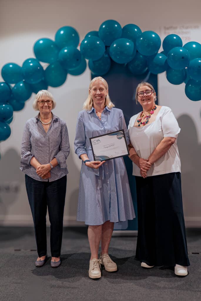 Surrey's ICV Scheme Manager Erika Dallinger holding award alongside Chair of ICVA Dame Anne Owers (left of image) and CEO of ICVA Sherry Ralph (right of image)